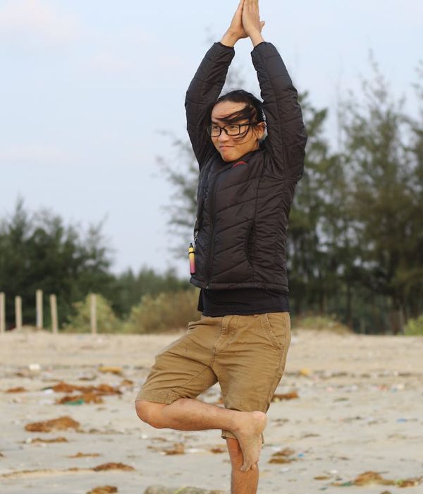 Man performing a balancing exercise showing focus and control in a calm environment.